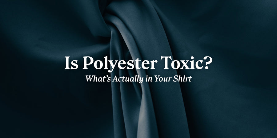 Is Polyester Toxic? What's Actually in Your Shirt. Close-up of dark teal synthetic satin folds.