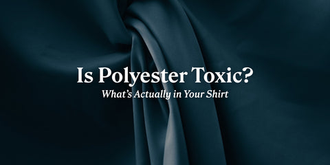 Is Polyester Toxic? What's Actually in Your Shirt. Close-up of dark teal synthetic satin folds.